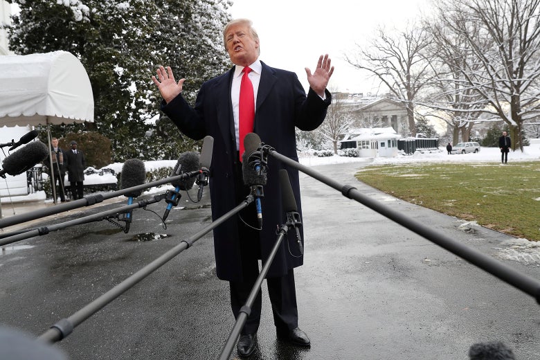 President Donald Trump raises his hands while speaking to the news media before boarding Marine One on Monday in Washington.